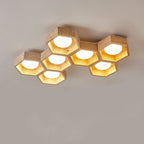 Seven hexagons in an offset cluster, travertine frames with the light glowing gold inside, on this Clérachic ceiling light.