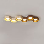 Six-cell Clérachic ceiling light in a long thin line, three travertine hexagons followed by three walnut-toned ones.