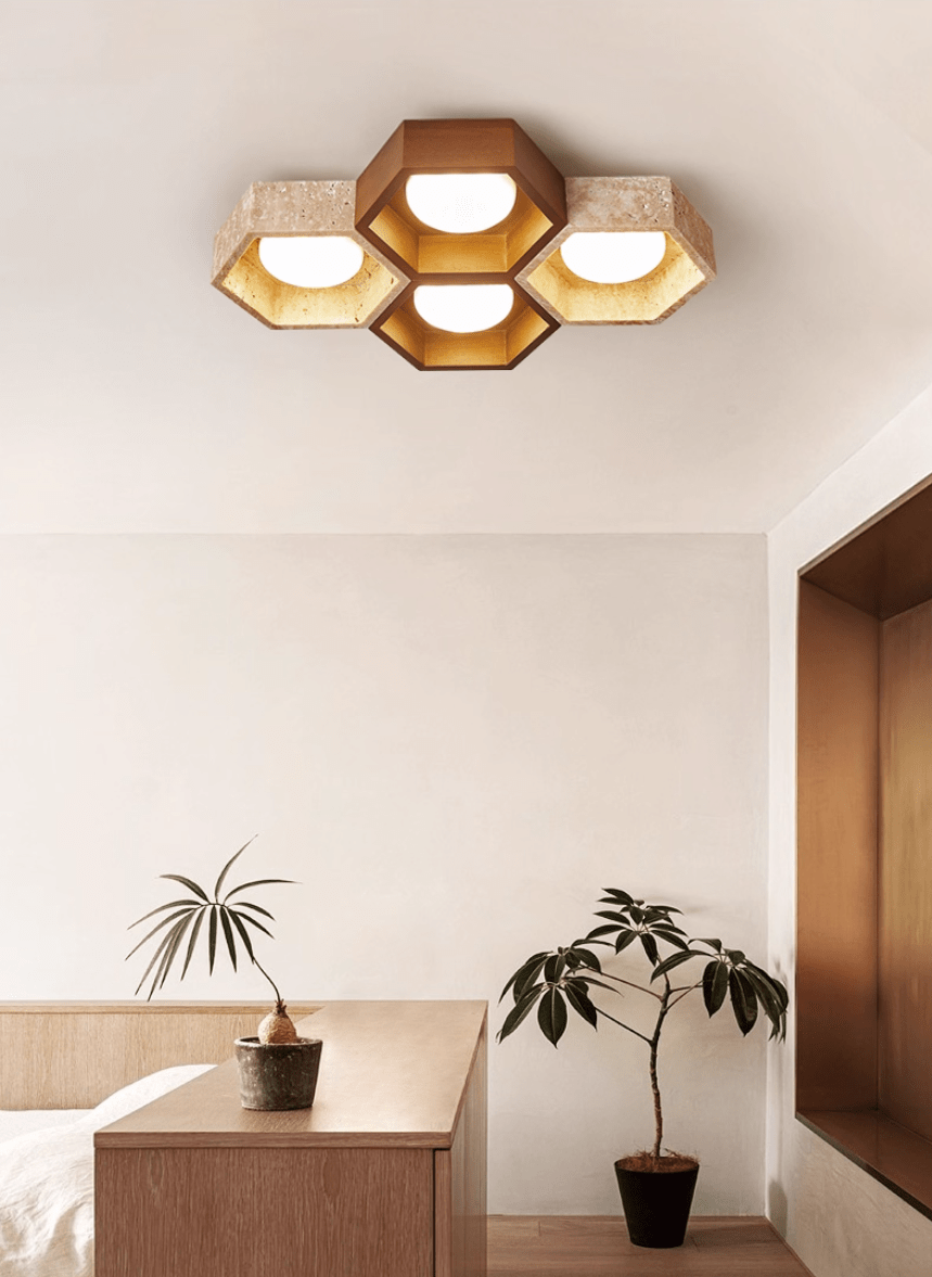 Four-cell Clérachic ceiling light with a walnut centre over a bedroom corner with a wooden console and a leafy plant.