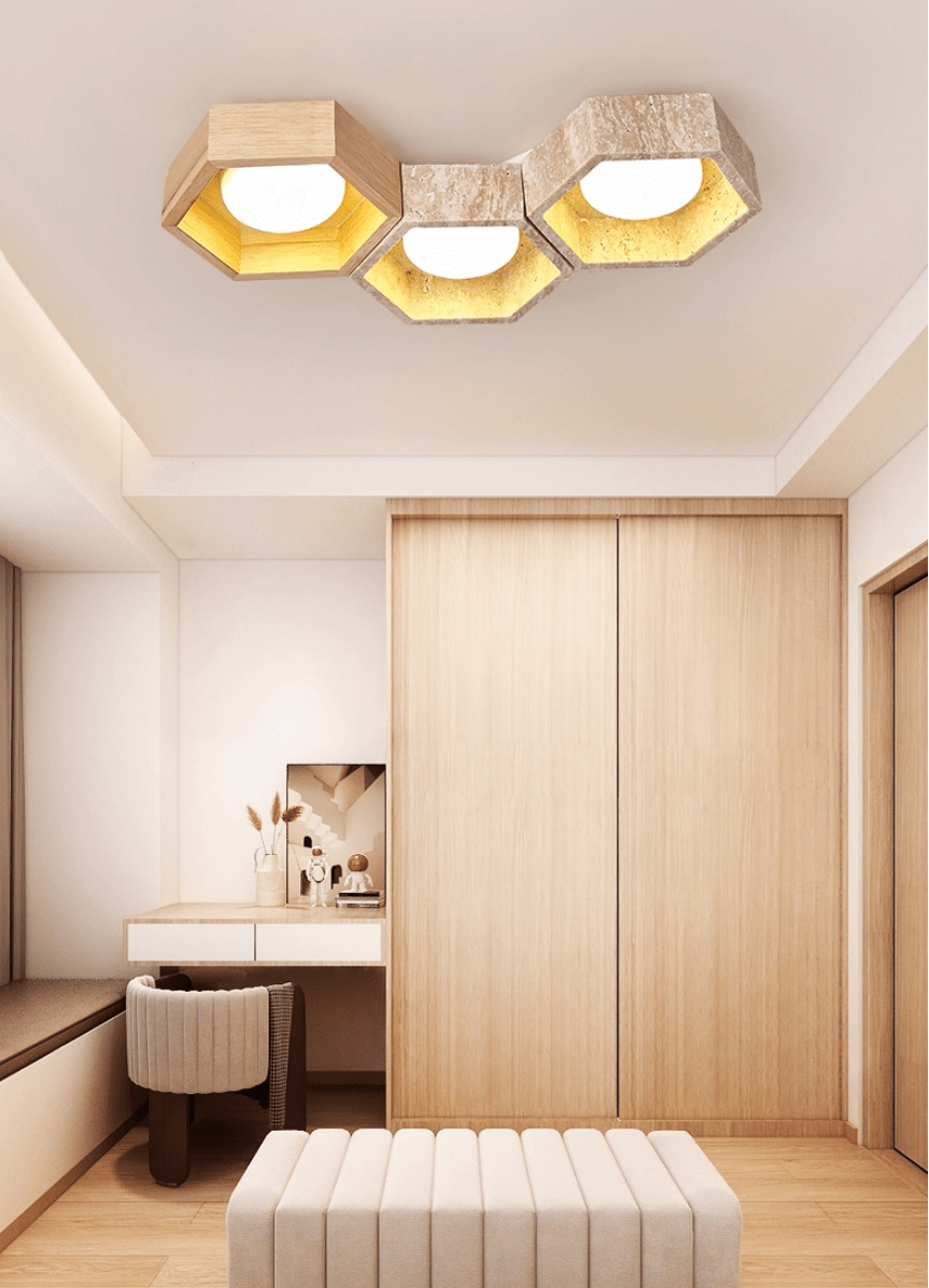 Three-cell Clérachic ceiling light above a dressing table and a cream upholstered stool, with a wood wardrobe behind.