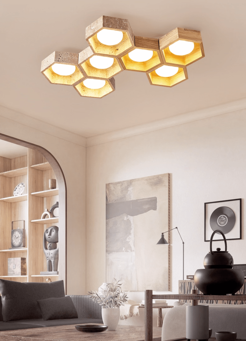 Seven-cell Clérachic ceiling light in a living room with an arched shelving alcove, a grey sofa and a black teapot.
