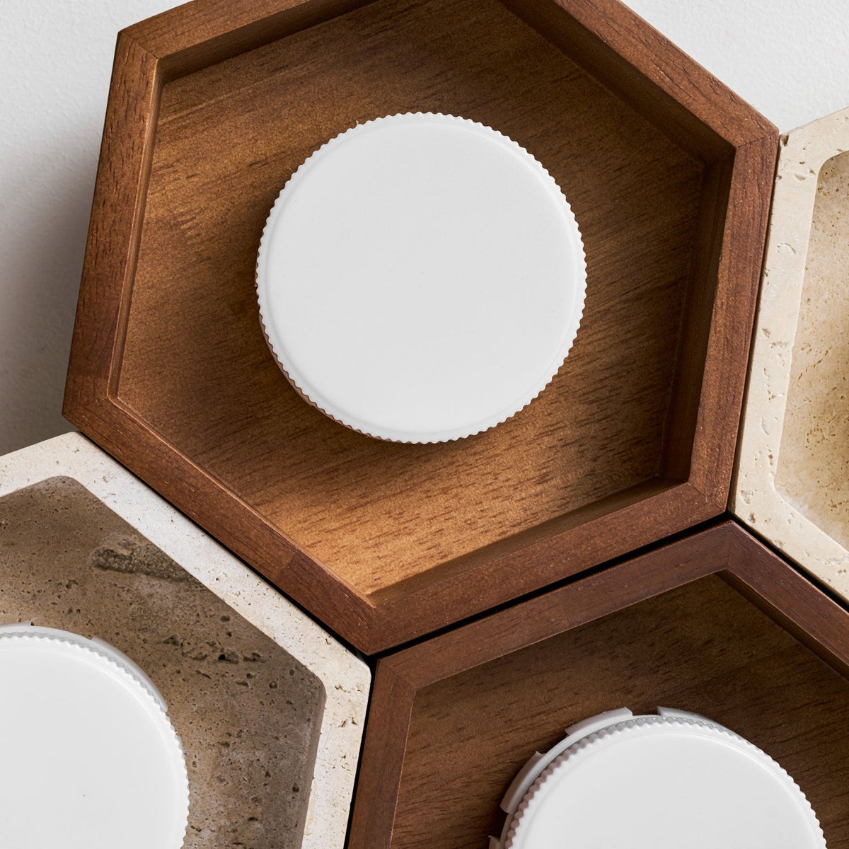 Close view of a walnut hexagon on this Clérachic ceiling light, showing the white ribbed disc lamp inside the wood frame.