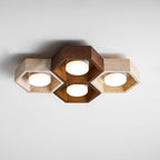 Side view of this Clérachic ceiling light with a walnut centre pair and travertine ends, the discs glowing softly.
