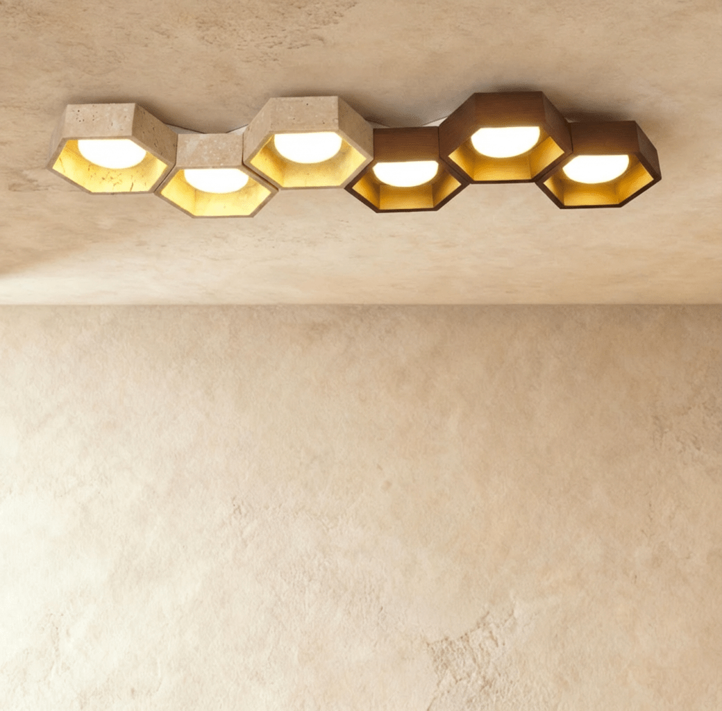 Clérachic six-head ceiling light, a long honeycomb of travertine and walnut hexagons with gold-leaf interiors and glowing globes.