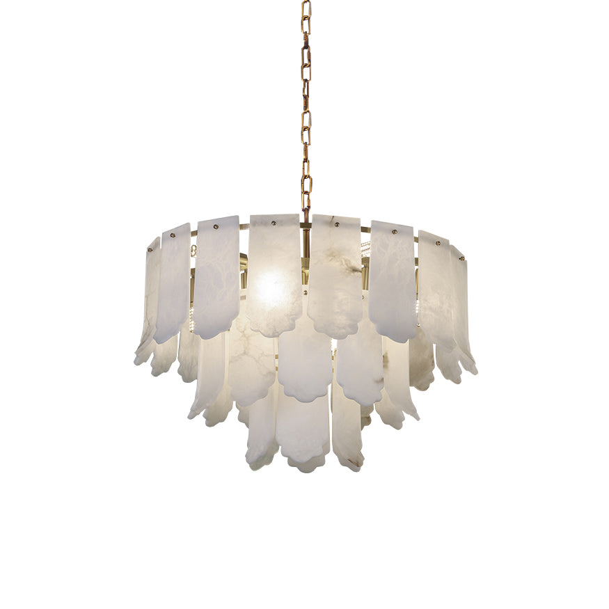 The Clérachic Hue Alabaster Chandelier lit and hung from its brass chain, photographed clear of any room on a white ground.
