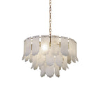 The Clérachic Hue Alabaster Chandelier lit and hung from its brass chain, photographed clear of any room on a white ground.