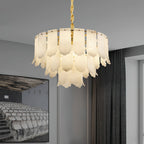 The Clérachic Hue Alabaster Chandelier lit beside herringbone curtains, its twisted brass stem dropping from a pale ceiling.