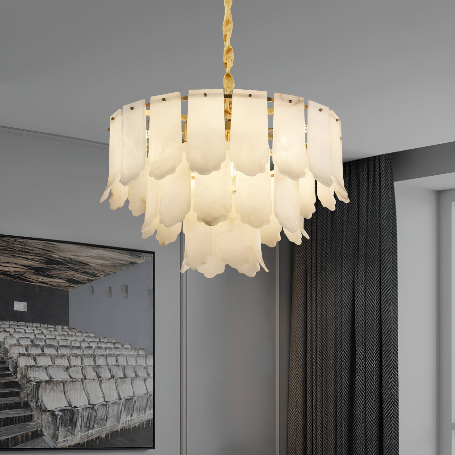 The Clérachic Hue Alabaster Chandelier lit beside herringbone curtains, its twisted brass stem dropping from a pale ceiling.