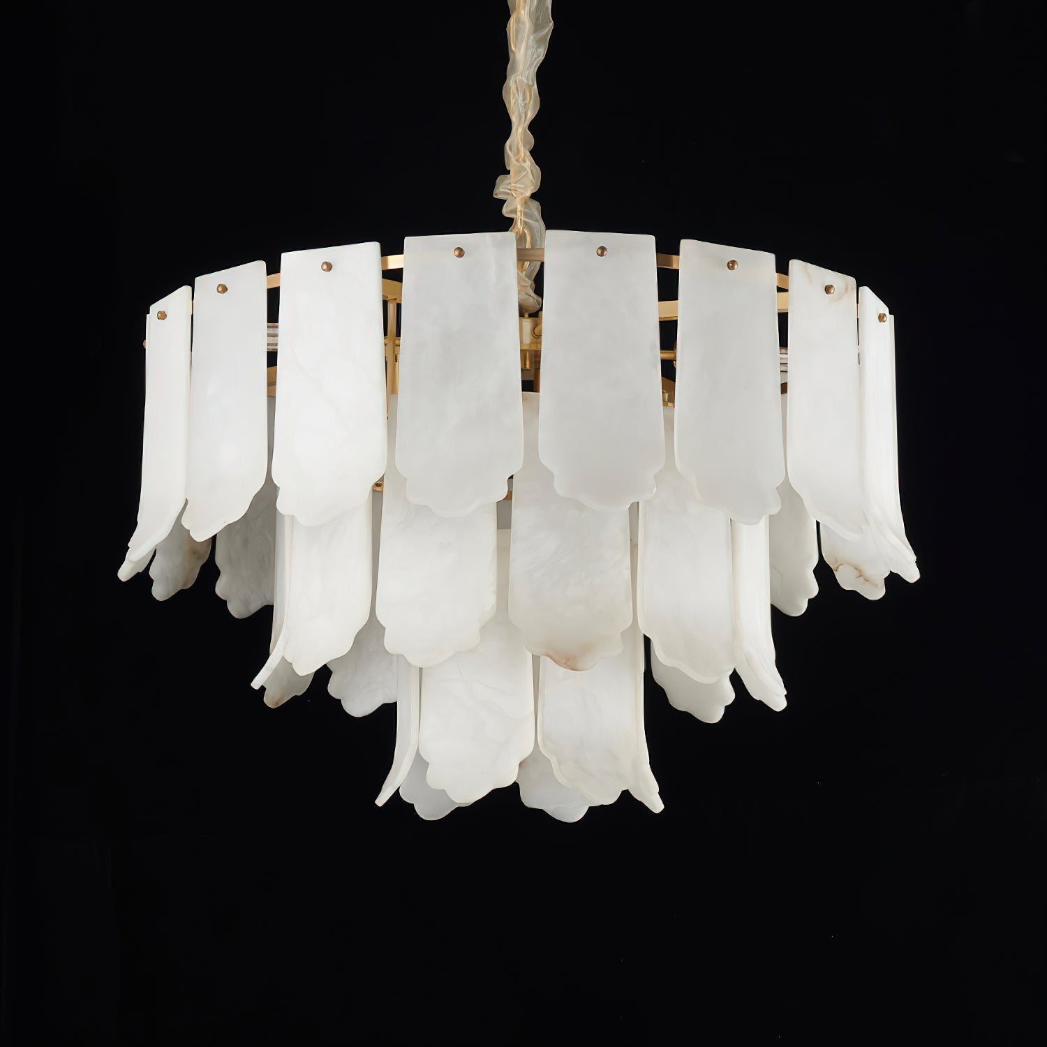 Studio shot on black of the Clérachic Hue Alabaster Chandelier, showing the scalloped hems and amber seams of each stone plate.