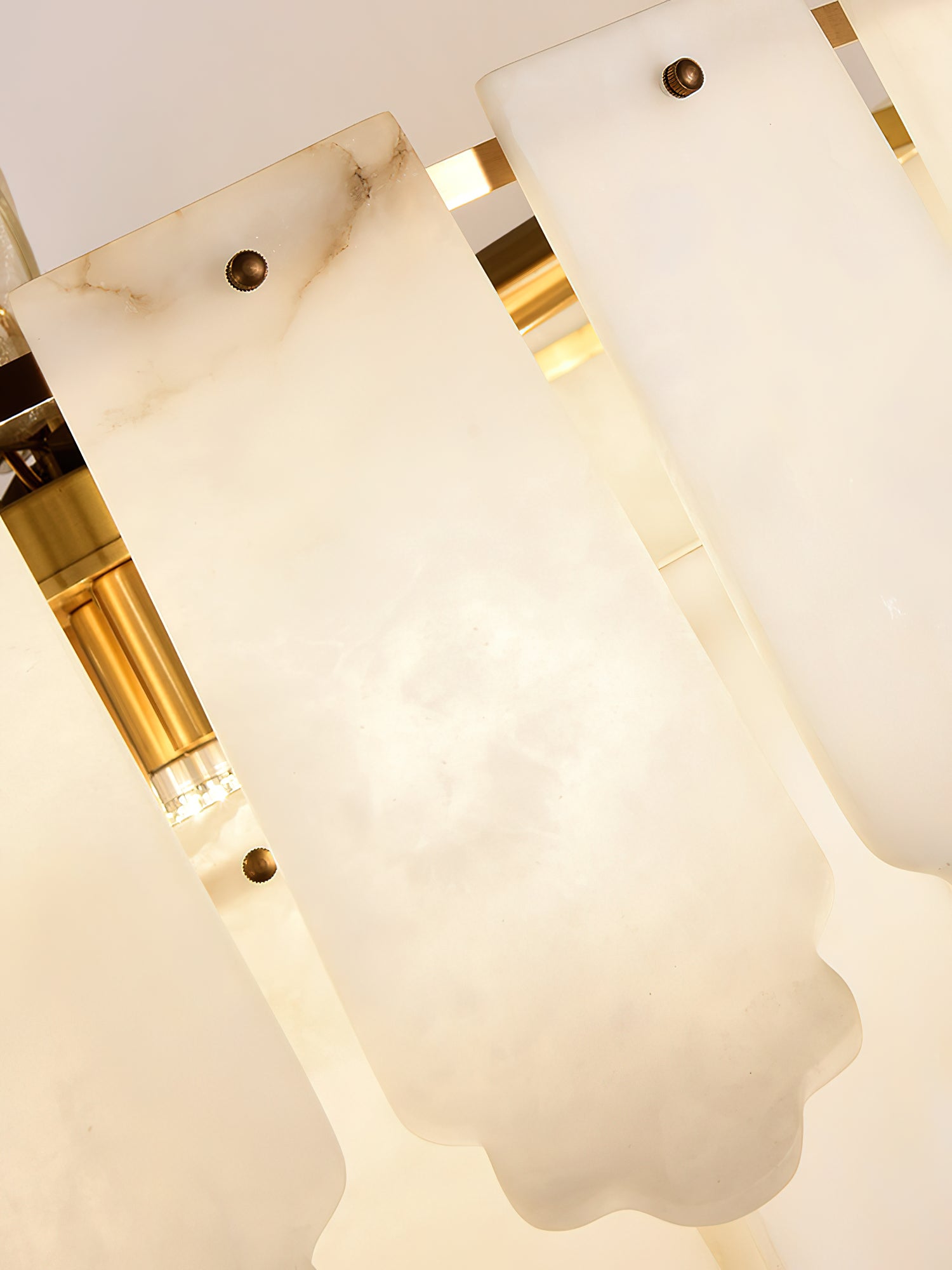 Looking up into the Clérachic Hue Alabaster Chandelier, warm light catching the brass ring between two lit alabaster plates.