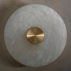 The Clérachic wall light seen straight on, showing how the alabaster edge is left raw and softly rounded.