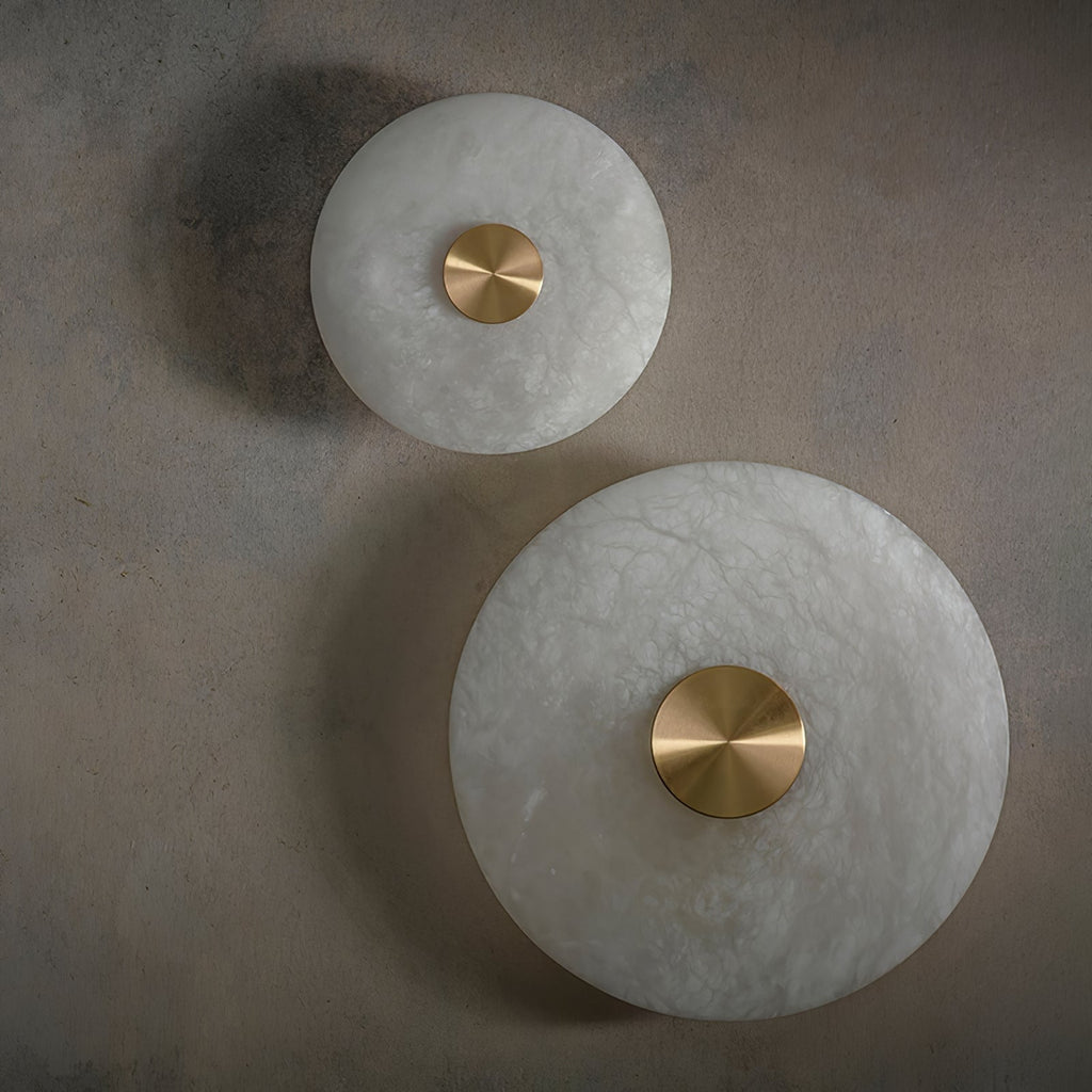 Clérachic wall lights in the small and large sizes, unlit, mounted one above the other on a plaster wall.