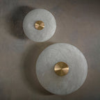 Clérachic sconces in both diameters, off, showing the tonal difference between two natural stone shades.