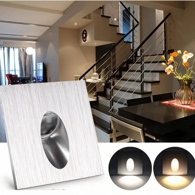 Clérachic brushed silver square stair light in front of an indoor staircase and dining area, with warm and cool glow swatches below.