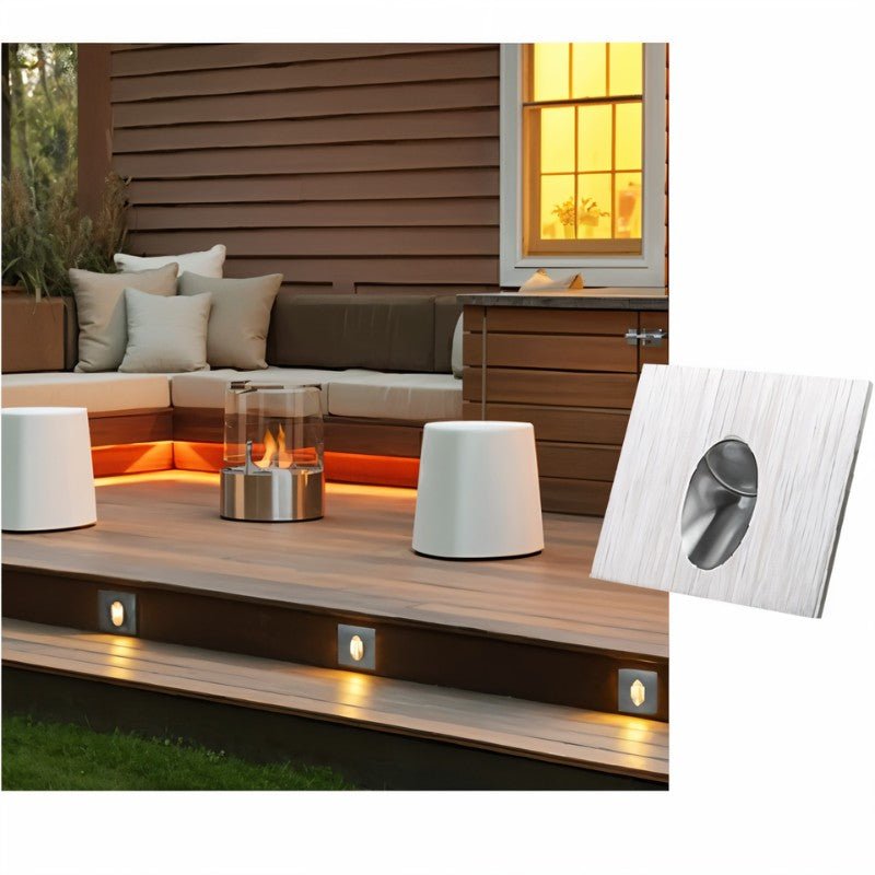 Clérachic square silver stair light beside a timber deck and seating area, with warm lights set into the deck step edge.