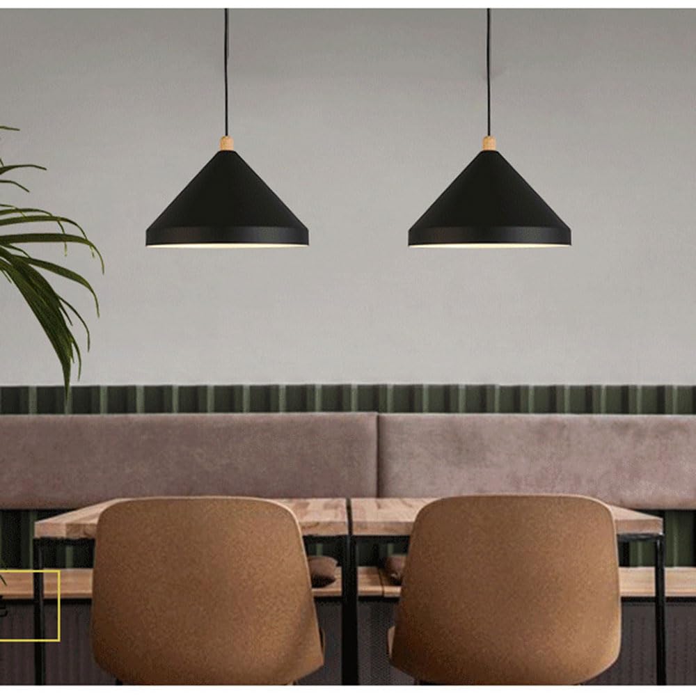 Two Clérachic black 1-light cone pendants hang over a pale wood café table and brown chairs.