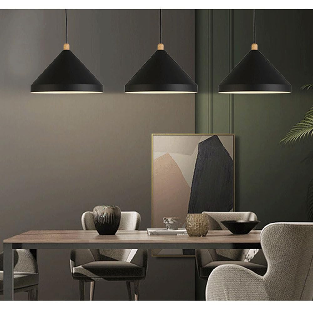 Three Clérachic black 1-light cone pendants hang in a row over a wood dining table and grey armchairs.