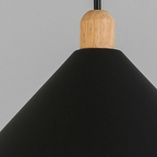 Close-up of the Clérachic black cone pendant, showing the light-wood cylinder where the black cord meets the shade.