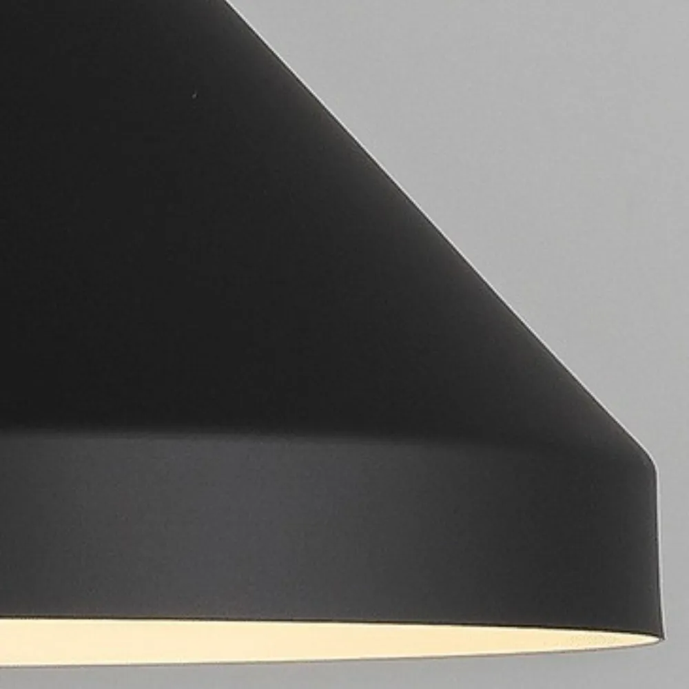 Close-up of the Clérachic black cone shade, matte exterior meeting a cream interior rim with a warm glow.