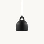 A black bell-shaped Clérachic pendant with a loop handle, hanging on a black cord against a plain off-white backdrop.