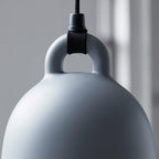 Close view of the loop handle and cord fitting on a grey Clérachic bell pendant, against a soft grey backdrop.