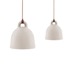 Two sand-coloured Clérachic bell pendants in different sizes, with brown cords, on a plain white backdrop.
