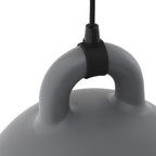 Close view of the cord fitting wrapped round the loop handle of a grey Clérachic bell pendant, on white.