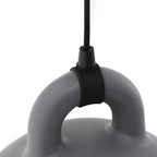 Close view of the black cord grip and handle of a grey Clérachic bell pendant, on a plain white backdrop.