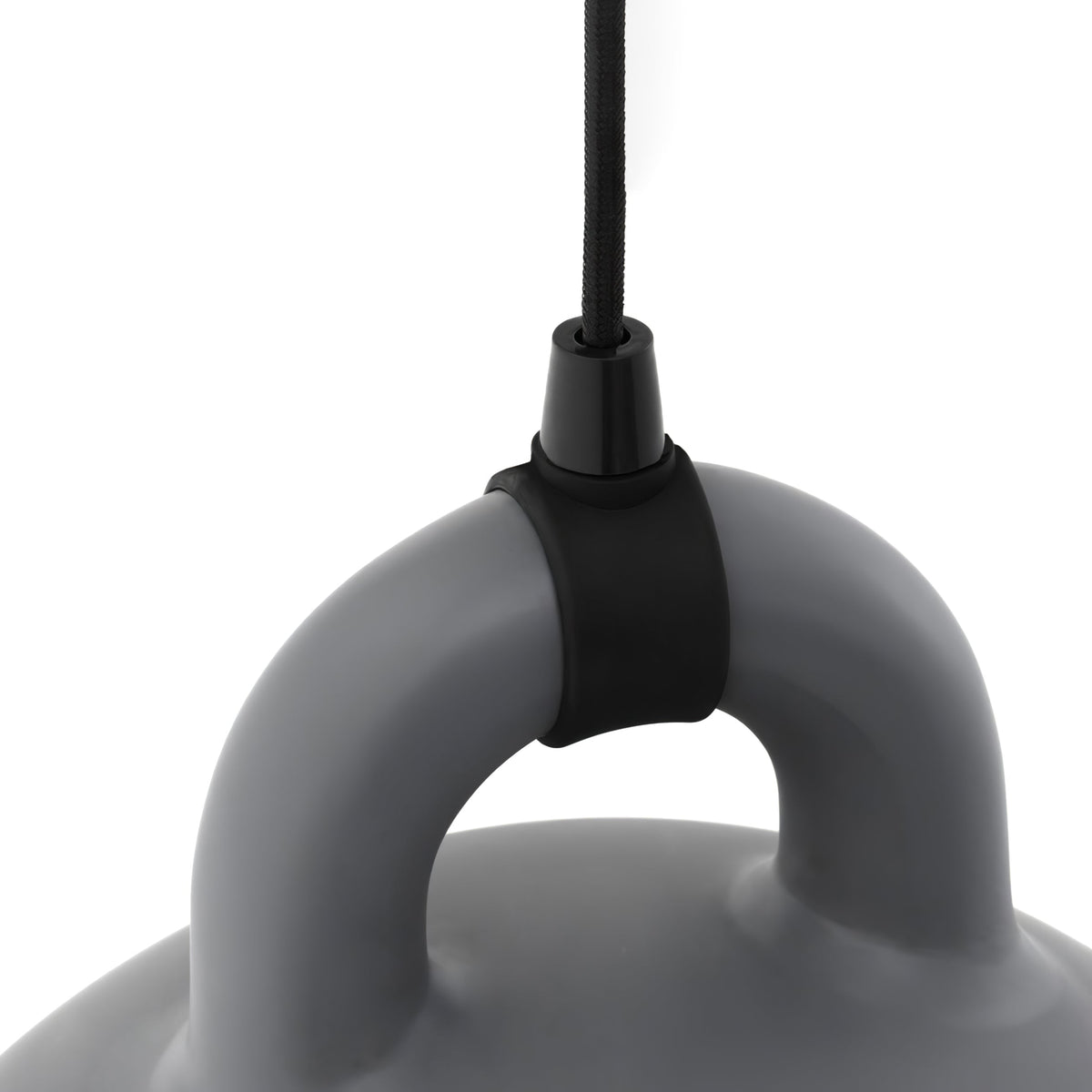 Close view of the black cord grip and handle of a grey Clérachic bell pendant, on a plain white backdrop.