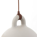 Close view of the brown cord fitting on the loop handle of a sand-coloured Clérachic bell pendant, on white.
