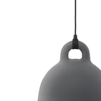 Cropped close view of the loop handle and shoulder of a grey Clérachic bell pendant, with its black cord, on white.