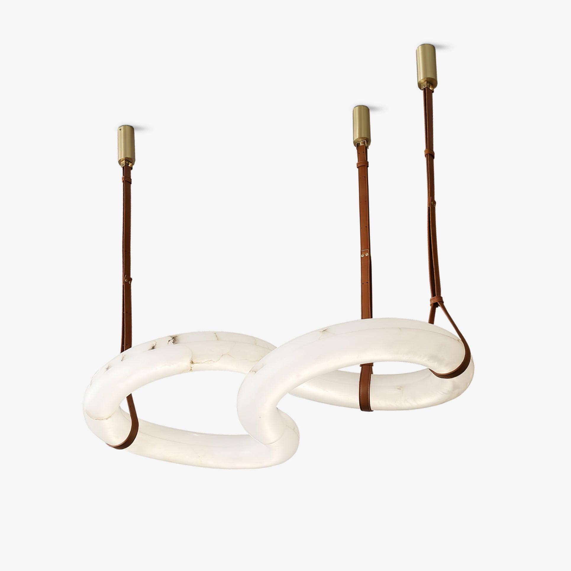 The Clérachic Infinity pendant from another angle, its alabaster rings linked and lit from within.