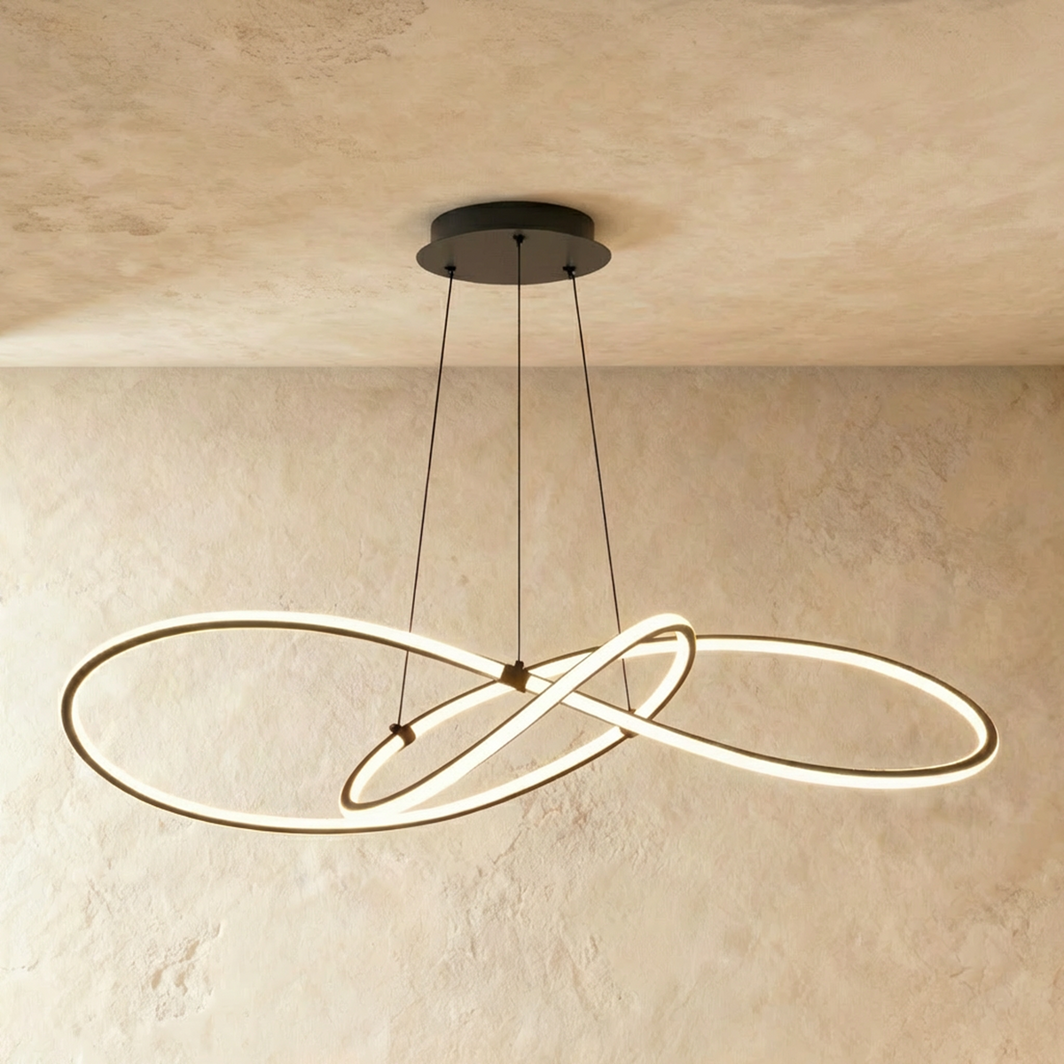 Clérachic longest black looped LED pendant, glowing along its full span beneath a round black ceiling canopy.