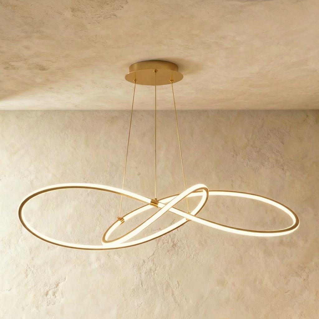 Clérachic longest brass looped LED pendant, its wide interlaced loops glowing under a round brass ceiling canopy.