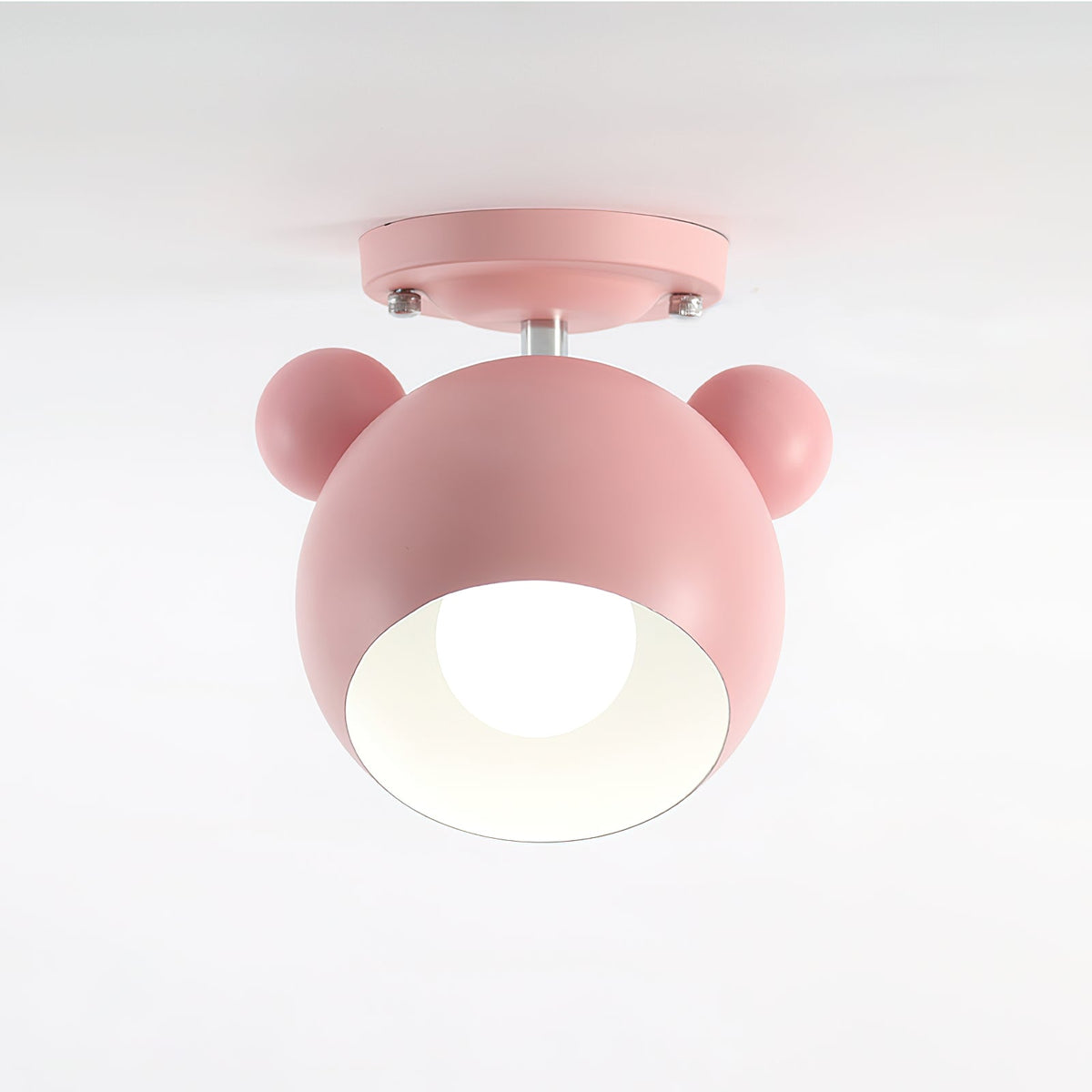 Pink Clérachic ceiling lamp with a bulb visible in its white-lined dome, shown against a pale grey backdrop.