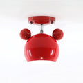Glossy red Clérachic ceiling lamp with round ears, a short stem and a red ceiling plate on a pale backdrop.