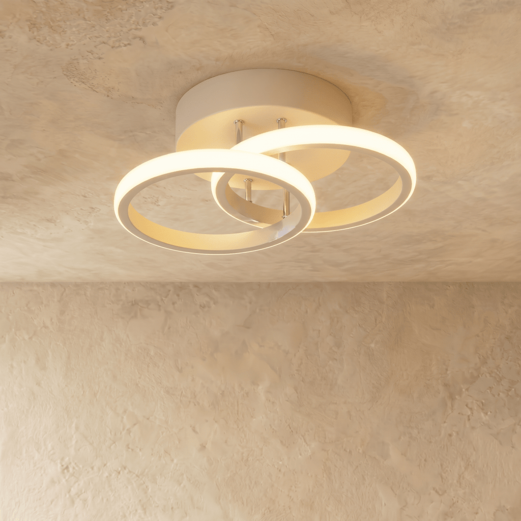 Clérachic white iron ceiling light with two overlapping glowing acrylic rings on a round canopy, flush on limewash plaster.