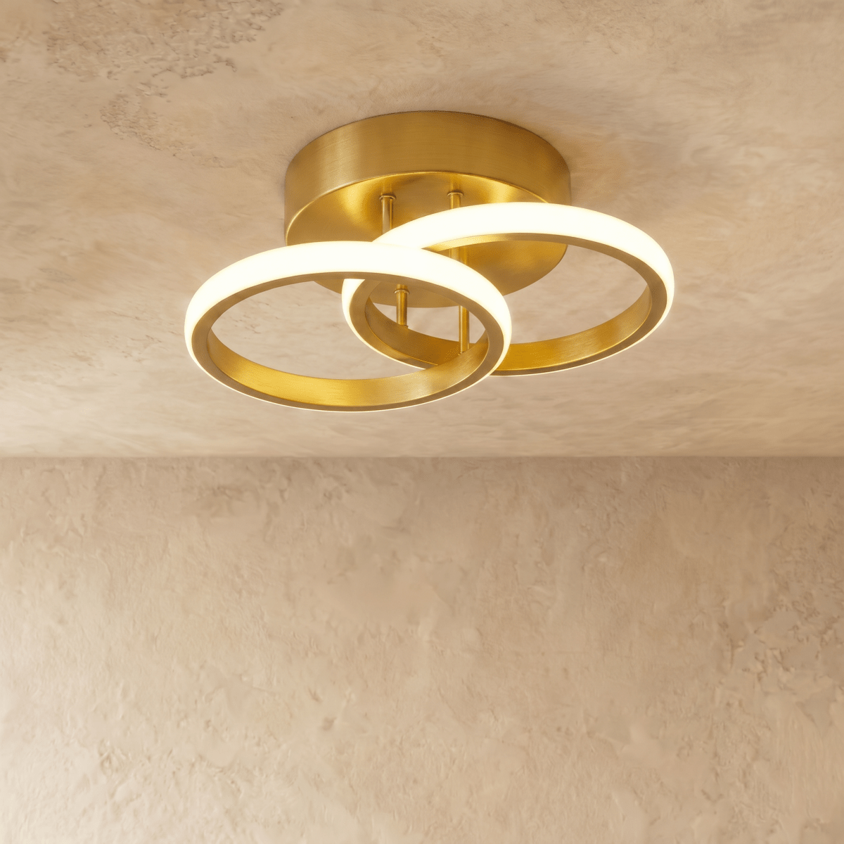 Clérachic brushed gold iron ceiling light with two overlapping glowing acrylic rings on a round canopy, on limewash plaster.