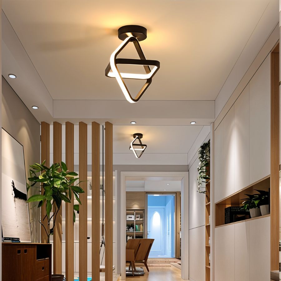 Clérachic black ceiling light of two interlocked glowing diamonds in a bright hallway with timber slats, plants and a sideboard.