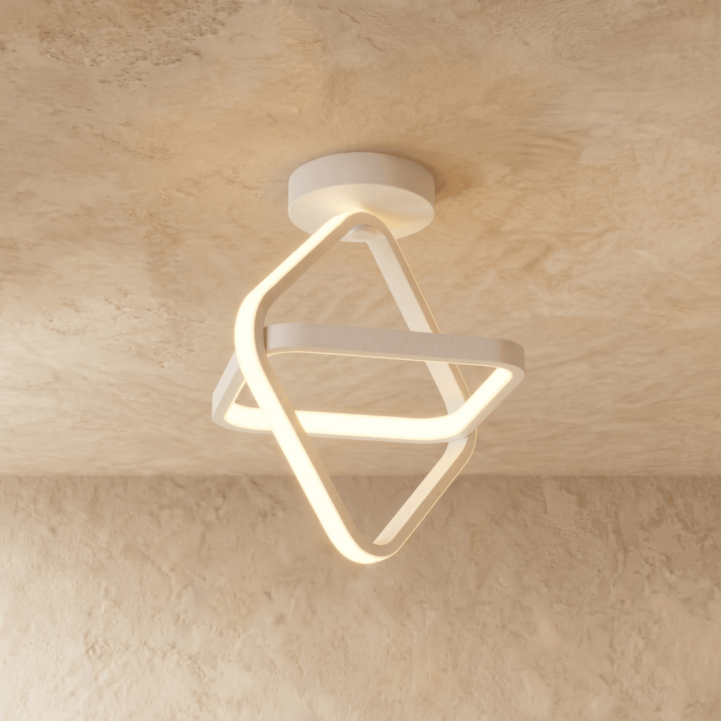 Clérachic white iron ceiling light of two interlocked tilted squares with a glowing acrylic edge, on a limewash ceiling.