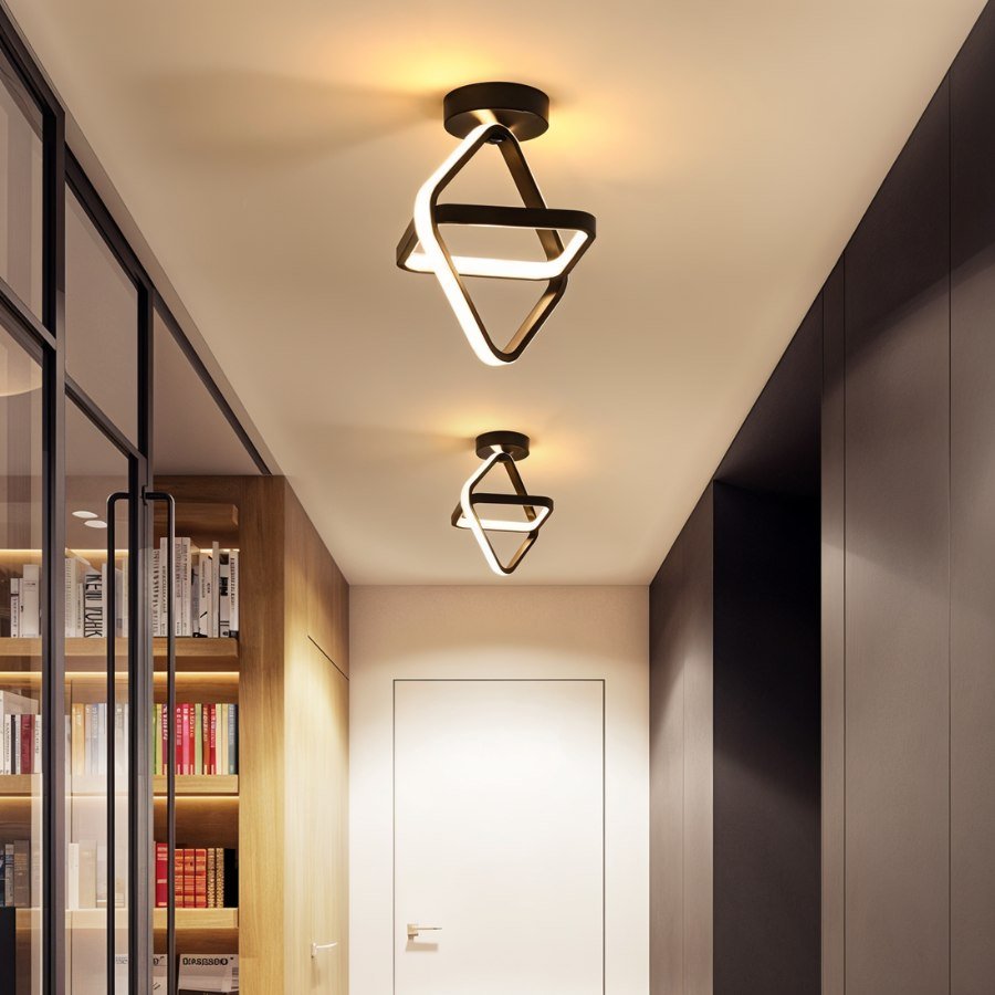Clérachic two black interlocked-diamond ceiling lights in a hallway beside a glazed door and a lit bookshelf.