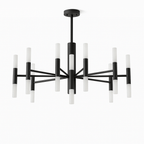 Clérachic stick chandelier in matte black with frosted upright tubes on radiating arms, shown unlit on white.