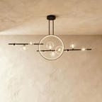 Clérachic's matte black iron chandelier pairs a slender ring with clear glass globe bulbs along a horizontal ceiling bar.
