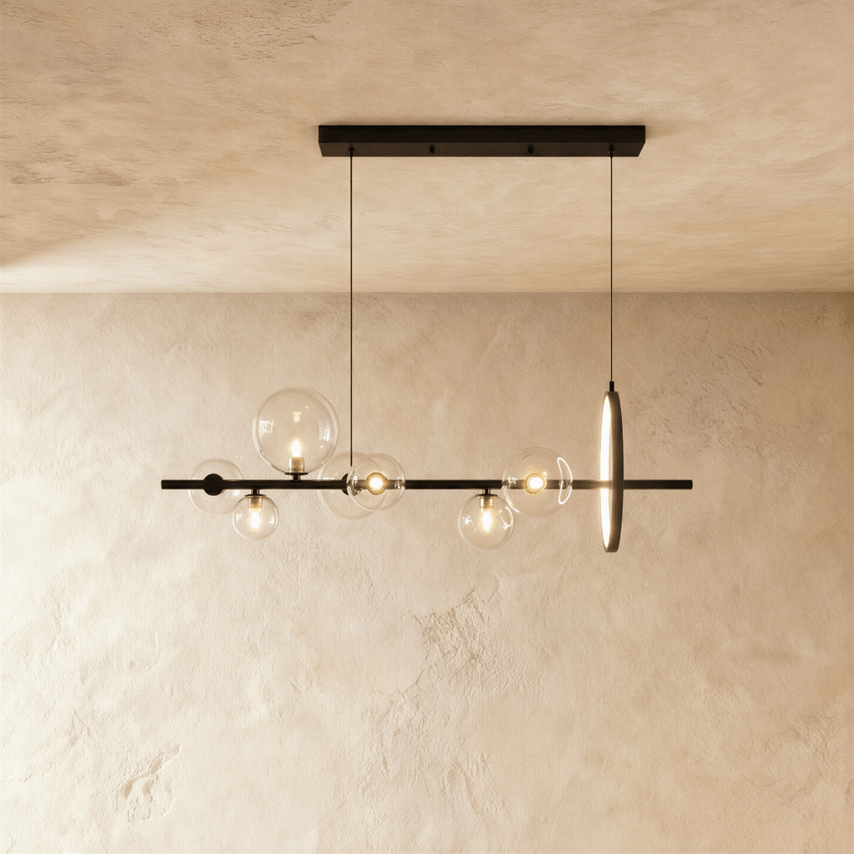 A Clérachic pendant combines clustered glass globe bulbs with a slim backlit halo disc, hung from a black ceiling bar.