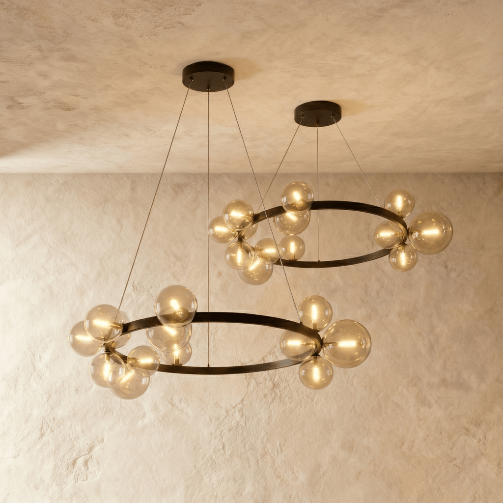 Two Clérachic ring chandeliers hang side by side from separate ceiling plates, each ringed with warm glass globes.