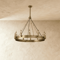 Clérachic compact brass ring chandelier with a dozen candle-style bulbs, black cords and a short stem on plaster.