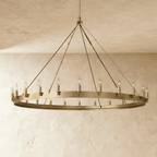 Clérachic large brass ring chandelier with candle-style bulbs around a flat band, hung from a long stem on plaster.