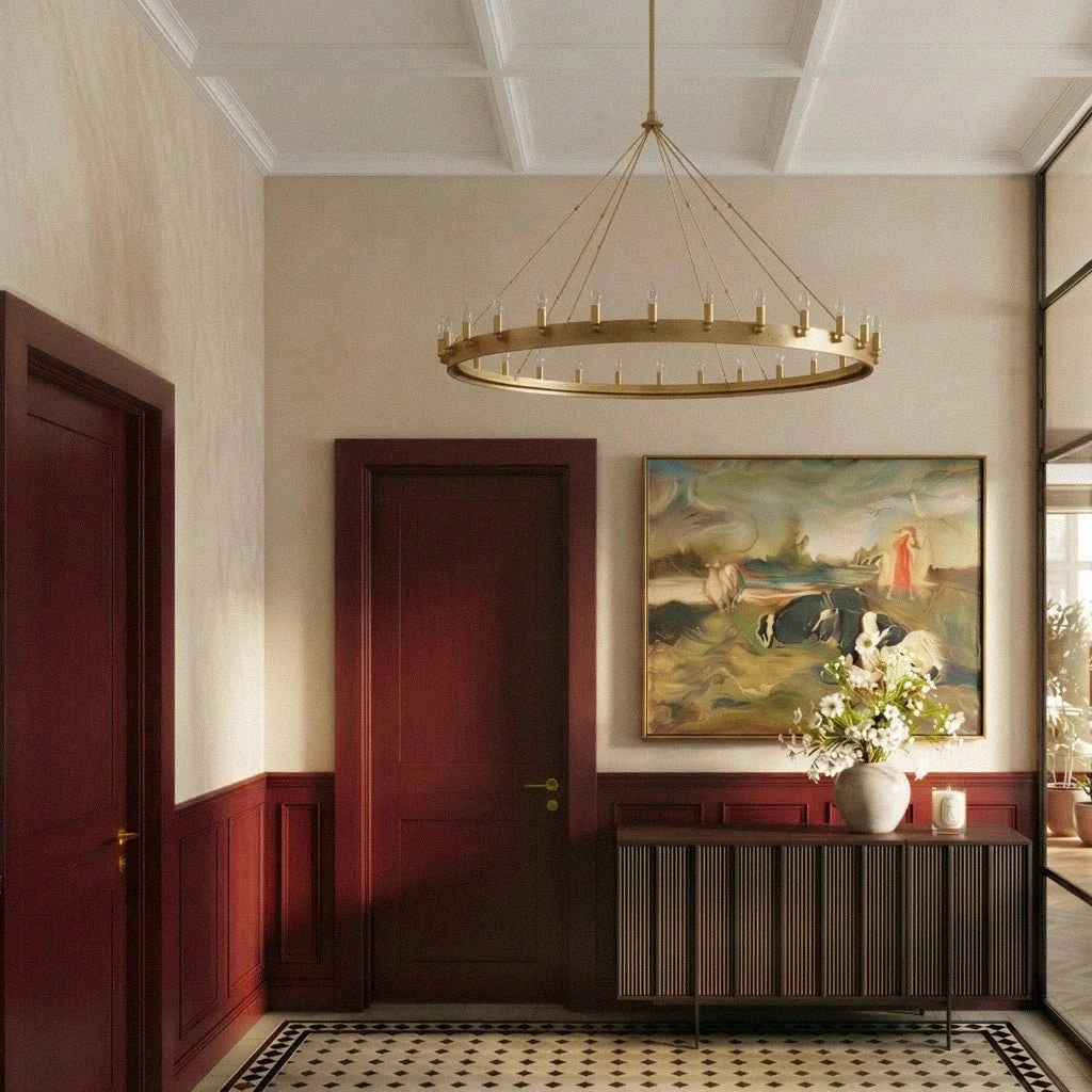 Clérachic wide brass ring chandelier hanging in a panelled hallway above a ribbed sideboard and large framed painting.