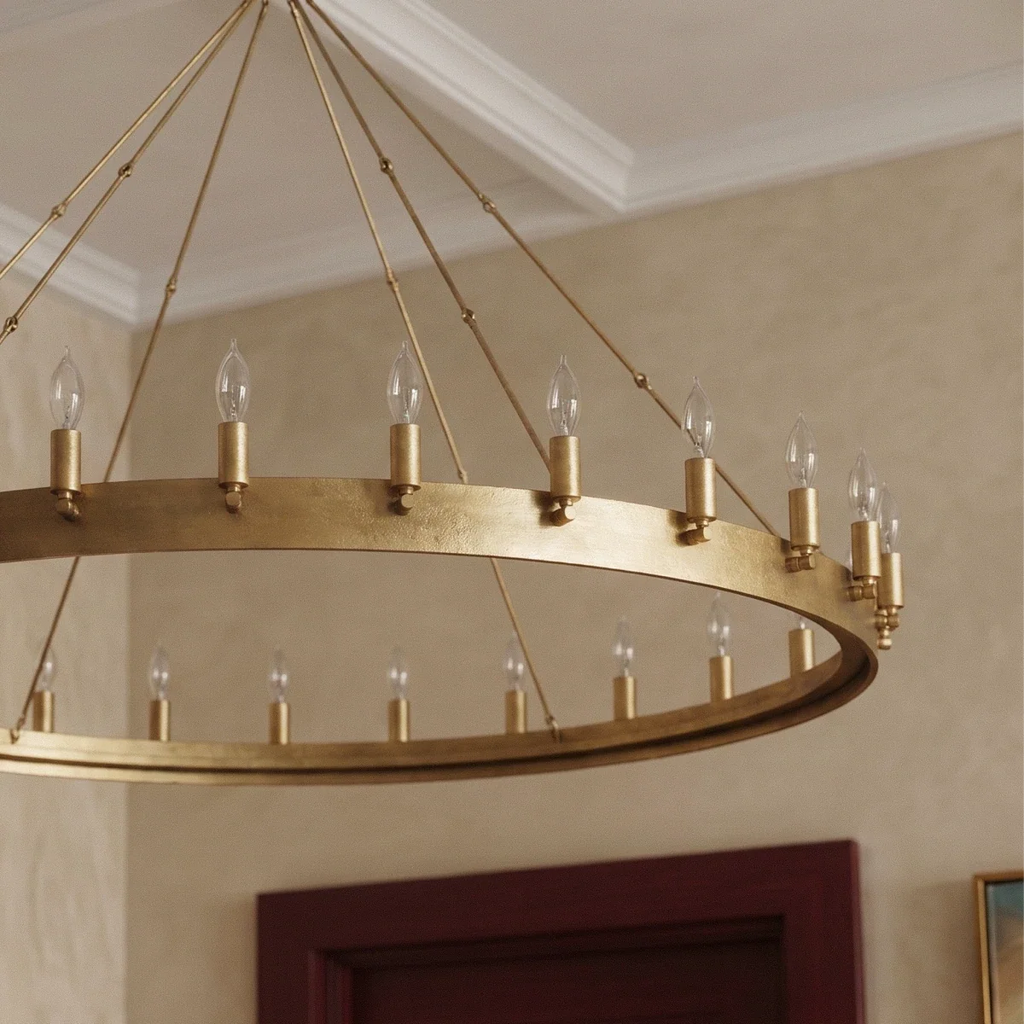 Close view of the Clérachic brass ring chandelier showing its hammered flat band, candle sleeves and clear bulbs.