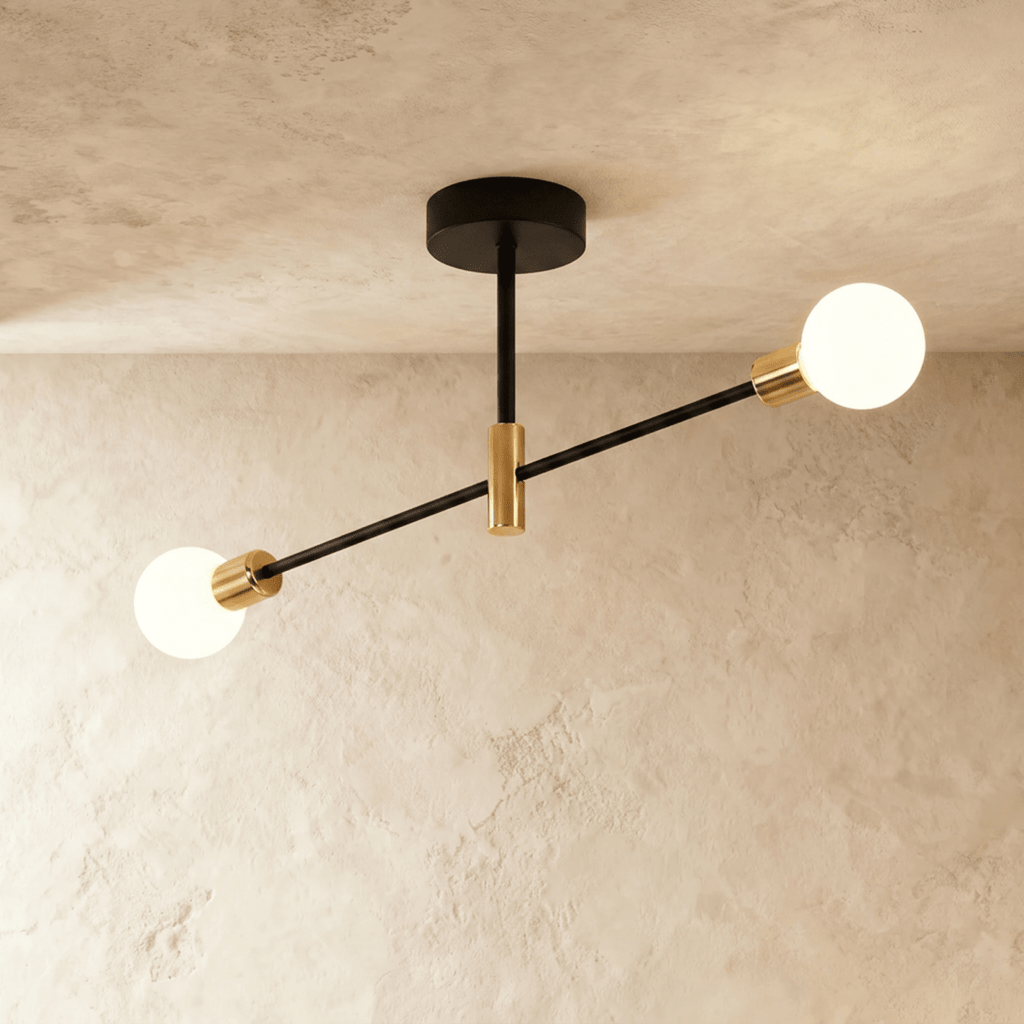 Clérachic 2-arm iron ring chandelier in black with brass sockets, frosted globe bulbs lit against a plaster ceiling.